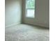 Bright, carpeted bedroom with a window providing natural light at 3536 Dogwood Pass, Lithonia, GA 30038