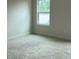 Bright bedroom with carpet and a window at 3536 Dogwood Pass, Lithonia, GA 30038