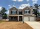 Charming two-story home with a welcoming front porch and a two-car garage at 3536 Dogwood Pass, Lithonia, GA 30038