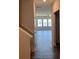 Inviting hallway showcasing hardwood floors leading to the living area with ample natural light at 3536 Dogwood Pass, Lithonia, GA 30038