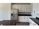Well-equipped kitchen featuring stainless steel refrigerator and ample cabinet space with dark countertops at 3536 Dogwood Pass, Lithonia, GA 30038
