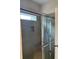 Modern shower featuring gray tile, a built-in niche, and sliding glass doors at 3536 Dogwood Pass, Lithonia, GA 30038