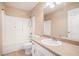 Well-lit bathroom featuring a shower-tub combo with white tiling and neutral wall paint at 55 Ashland Farm Rd, Oxford, GA 30054