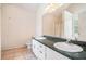 Bathroom featuring double sinks, tiled floors, and a large mirror at 55 Ashland Farm Rd, Oxford, GA 30054