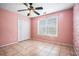 Bedroom featuring tiled flooring, ceiling fan, and a closet at 55 Ashland Farm Rd, Oxford, GA 30054