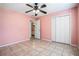 Bedroom featuring tiled flooring, ceiling fan, and entry into the bathroom at 55 Ashland Farm Rd, Oxford, GA 30054