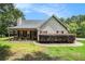 Charming home featuring a covered front porch and stone accents enhancing its curb appeal at 55 Ashland Farm Rd, Oxford, GA 30054
