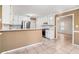 Well-lit kitchen features white cabinets, stainless steel appliances and tiled flooring at 55 Ashland Farm Rd, Oxford, GA 30054