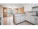 Bright kitchen featuring white cabinets, tile flooring and an open breakfast nook area at 55 Ashland Farm Rd, Oxford, GA 30054