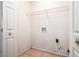 Laundry room features tiled floors and a wired rack for extra storage capacity at 55 Ashland Farm Rd, Oxford, GA 30054