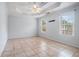 Spacious main bedroom features a tray ceiling, ceiling fan, and tiled floors at 55 Ashland Farm Rd, Oxford, GA 30054
