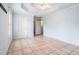 Spacious main bedroom with tiled flooring, ceiling fan, and two entry doorways at 55 Ashland Farm Rd, Oxford, GA 30054