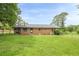 Brick home's fenced backyard featuring a screened porch and lush green lawn at 5709 Center Hill Church Rd, Loganville, GA 30052