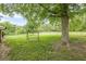 Expansive backyard with mature trees, swing, and a fenced-in yard at 5709 Center Hill Church Rd, Loganville, GA 30052