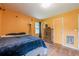 Bright bedroom featuring hardwood floors, a cozy bed, and a window for natural light at 5709 Center Hill Church Rd, Loganville, GA 30052