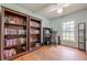 Office/Bedroom with hardwood floors, a ceiling fan, and built-in bookshelves at 5709 Center Hill Church Rd, Loganville, GA 30052