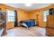 Bedroom featuring wood floors, large window, and closet space at 5709 Center Hill Church Rd, Loganville, GA 30052