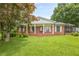 Charming brick home featuring a covered front porch and well-maintained lawn in a serene setting at 5709 Center Hill Church Rd, Loganville, GA 30052