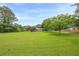 Expansive front yard, mature trees frame this charming home at 5709 Center Hill Church Rd, Loganville, GA 30052