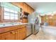 Bright kitchen with stainless steel refrigerator, double basin sink, and adjacent living space at 5709 Center Hill Church Rd, Loganville, GA 30052