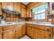 Cozy kitchen with wood paneling, laminate countertops and essential appliances at 5709 Center Hill Church Rd, Loganville, GA 30052