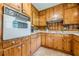 Country style kitchen featuring natural wood cabinets, white countertops, and tile flooring at 5709 Center Hill Church Rd, Loganville, GA 30052