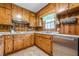 Functional kitchen featuring wooden cabinets, laminate countertops, and essential appliances at 5709 Center Hill Church Rd, Loganville, GA 30052