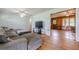 Cozy living room with hardwood floors and access to an adjacent wood-paneled room at 5709 Center Hill Church Rd, Loganville, GA 30052