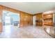 Living space featuring wood paneled walls and adjacent living area at 5709 Center Hill Church Rd, Loganville, GA 30052