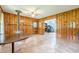 Living space features wood burning stove, wood paneled walls, and tile flooring at 5709 Center Hill Church Rd, Loganville, GA 30052