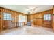 Cozy living space with wood paneled walls, wood burning stove, and access to outdoors at 5709 Center Hill Church Rd, Loganville, GA 30052