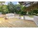 Spacious wooden deck overlooking backyard with storage shed, basketball court, and lush greenery at 2010 2Nd Ave, Decatur, GA 30032