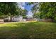 Expansive backyard with lush lawn, mature trees, storage shed, and basketball court at 2010 2Nd Ave, Decatur, GA 30032