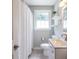 A well-lit bathroom with modern fixtures, a neutral color scheme and a shower with tub at 2010 2Nd Ave, Decatur, GA 30032