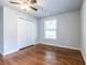 Cozy bedroom featuring hardwood floors, a ceiling fan, a closet and a sunlit window at 2010 2Nd Ave, Decatur, GA 30032