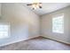 Neutral bedroom with a fan, plush carpet, and natural light from two windows at 2010 2Nd Ave, Decatur, GA 30032