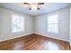Spacious bedroom with hardwood floors, two windows that provide natural light, and neutral wall paint at 2010 2Nd Ave, Decatur, GA 30032