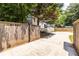 Wide driveway leads to a backyard with a detached garage and basketball hoop, enclosed by a wooden fence at 2010 2Nd Ave, Decatur, GA 30032