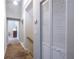 Hallway featuring neutral paint, carpet flooring, a closet with folding doors, and an open doorway to another room at 2010 2Nd Ave, Decatur, GA 30032