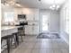 A well lit kitchen features granite countertops, white cabinetry and stainless steel appliances plus a dining area at 2010 2Nd Ave, Decatur, GA 30032
