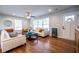 Bright living room with hardwood floors, large windows, and stylish furnishings, offering a cozy space at 2010 2Nd Ave, Decatur, GA 30032