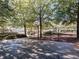 This basketball court is set among mature trees and a metal fence at 232 Oconee Way, Canton, GA 30114