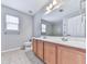 The bright bathroom features a double sink vanity and tiled floors and shower at 232 Oconee Way, Canton, GA 30114