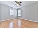 Neutrally decorated bedroom with wood flooring, ceiling fan and bright windows at 232 Oconee Way, Canton, GA 30114