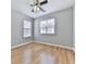 Bedroom with gray walls, ceiling fan, bright windows, and pristine wood flooring at 232 Oconee Way, Canton, GA 30114