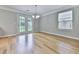 Sun-drenched dining area features hardwood floors and access to outdoors at 232 Oconee Way, Canton, GA 30114