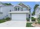 Charming two-story home with a two-car garage, stone accents, and a well-maintained front lawn at 232 Oconee Way, Canton, GA 30114