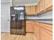 Bright kitchen featuring stainless steel refrigerator, wood cabinets, and light countertops at 232 Oconee Way, Canton, GA 30114