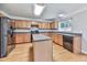 Well-equipped kitchen features an island, stainless steel appliances, and wood cabinets at 232 Oconee Way, Canton, GA 30114