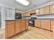 Updated kitchen showcasing wood cabinets, modern appliances, and plenty of storage at 232 Oconee Way, Canton, GA 30114